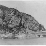 The base of Maryland Heights across from Harpers Ferry, and the covered railroad bridge, in 1859 (Library of Congress)