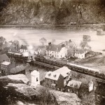 A train filled with Union soldiers bound for the front lines of the war c.1864 sits on the tracks of the Winchester and Potomac Railroad in Harpers Ferry (Bowlsby, photographer; United States Military Academy, West Point)