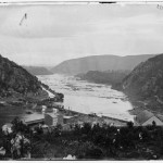 A photograph of lower town Harpers Ferry in 1865, showing the reconstructed railroad bridge (1865, James Gardner, photographer; Library of Congress)